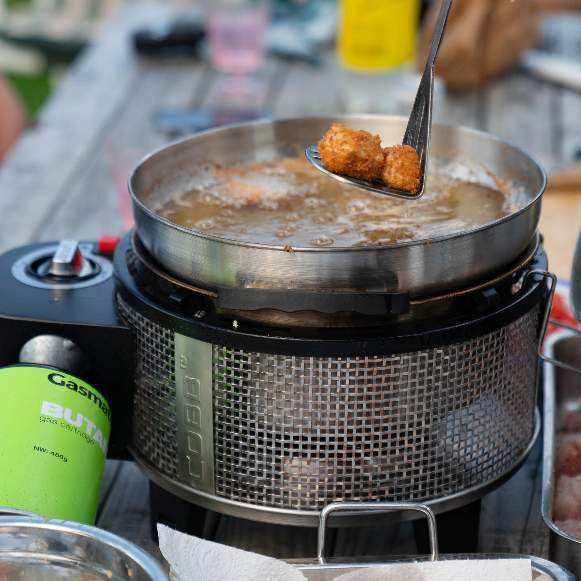 Deep frying in the COBB Grill NZ portable BBQ wok accessory